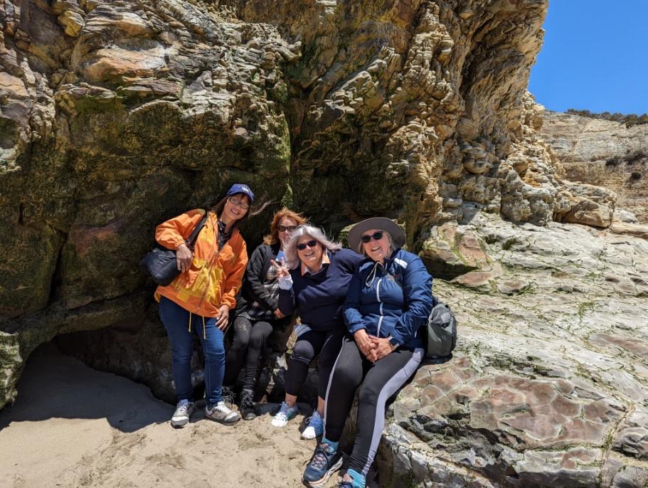 Four Stitch members smile while hiking