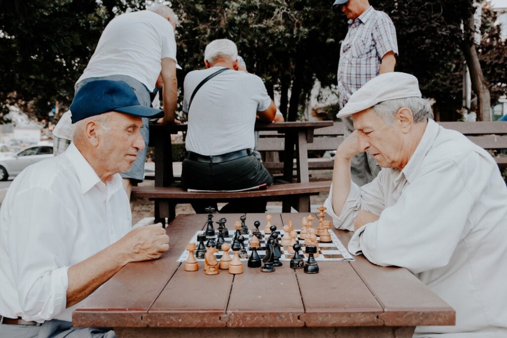 Older men enjoy a game of chess together.