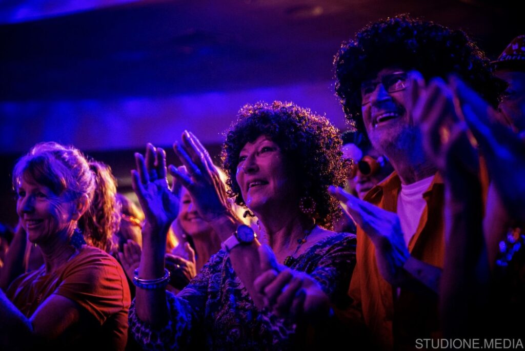 Partygoers cheering on the band.