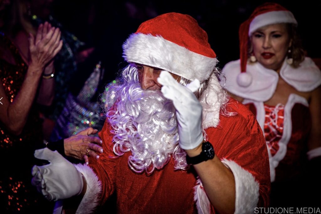 Santa Claus makes an appearance, waving at the crowd