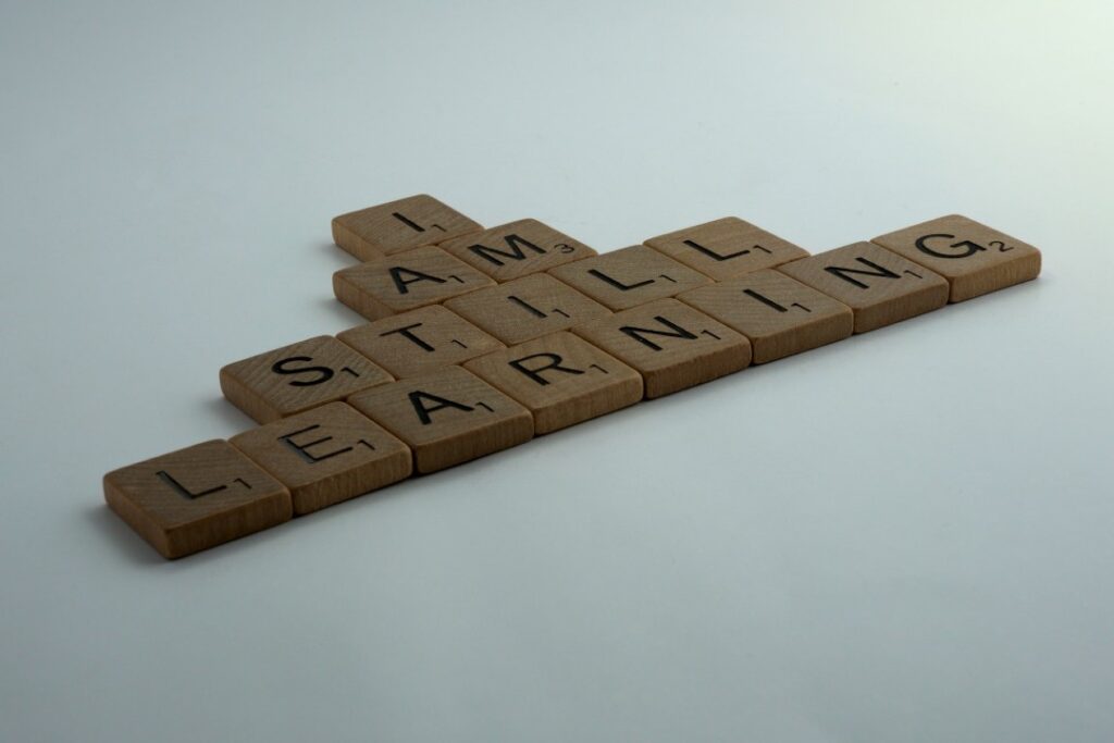 Scrabble letters arranged to say "I am still learning'