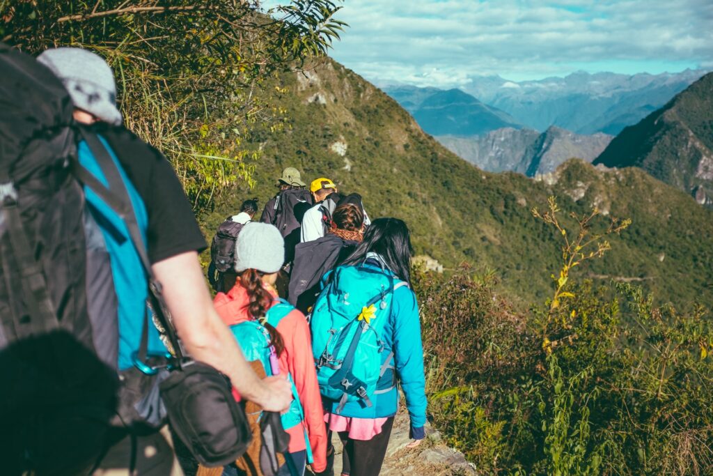 A hiking group traversing a picturesque mountainside