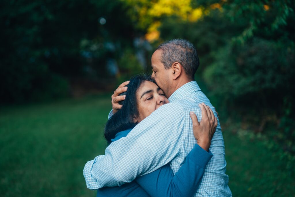 Two people holding each other in a comforting embrace