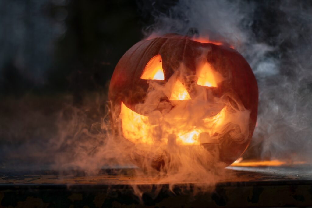 A jack-o-lantern in a haze of smoke