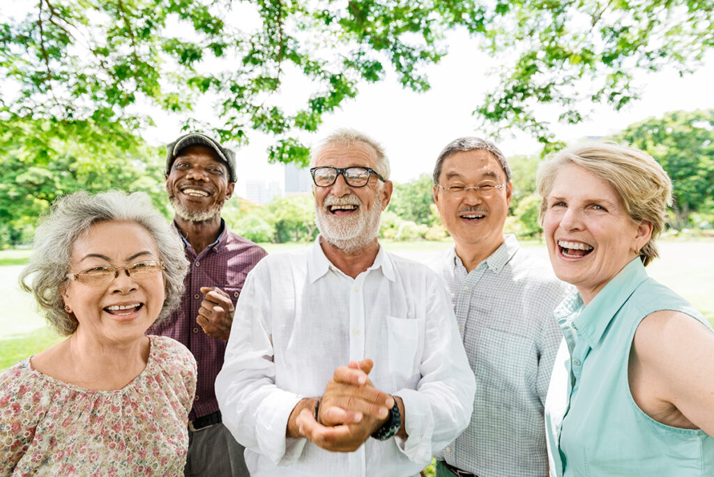 Group of happy older adults smiling in a park